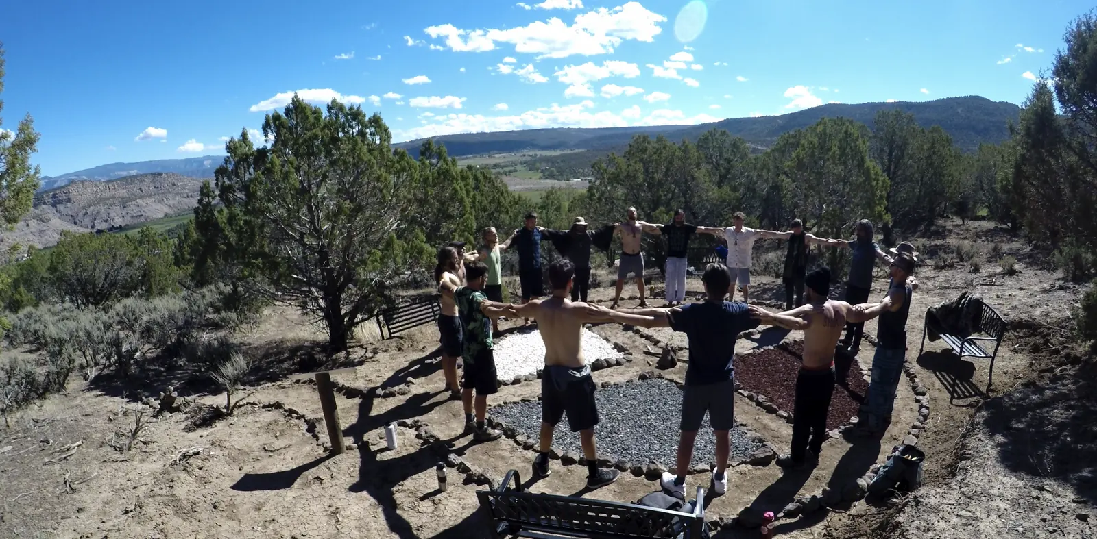 A men's retreat circle gathered on a Colorado overlook